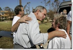 President George W. Bush comforts residents during a walking tour of neighborhoods damaged by Hurricane Ivan in Pensacola, Florida, Sunday, Sept. 19, 2004. White House photo by Eric Draper.