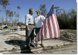 President George W. Bush talks with resident Jim Heinold during a walking tour of neighborhoods damaged by Hurricane Ivan in Pensacola, Florida, Sunday, Sept. 19, 2004 White House photo by Eric Draper.