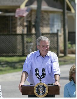 President George W. Bush smiles as he addresses his remarks to residents and state community leaders Monday, Aug. 28, 2006, following his walking tour through the Biloxi, Miss., neighborhood he visited following Hurricane Katrina in September 2005. The tour allowed President Bush the opportunity to assess the progress of the areas recovery and rebuilding efforts a year after the devastating hurricane. White House photo by Eric Draper