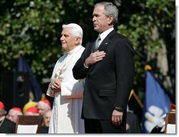 President George W. Bush and Pope Benedict XVI stand together during the playing of the National Anthem at the Popes welcoming ceremony on the South Lawn of the White House Wednesday, April 16, 2008. White House photo by Shealah Craighead